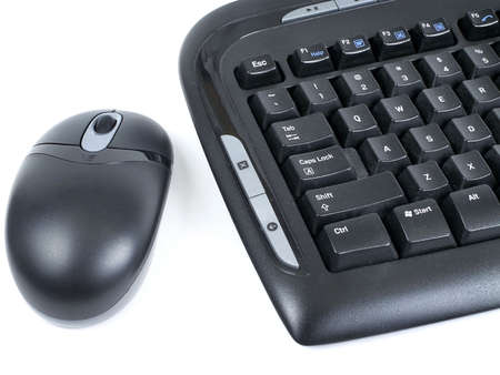 Close-up of wireless black mouse and computer keyboard isolated on white background.の写真素材