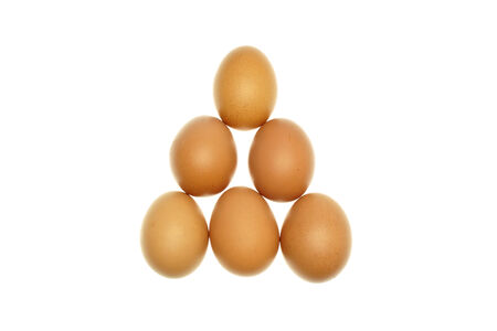 Brown eggs put as triangle isolated with a white background 