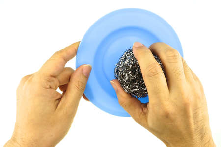 Hand hold wool pot cleaning blue dish isolated with white .の写真素材
