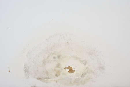 Peeling paint from rain on old ceiling use for background texture.