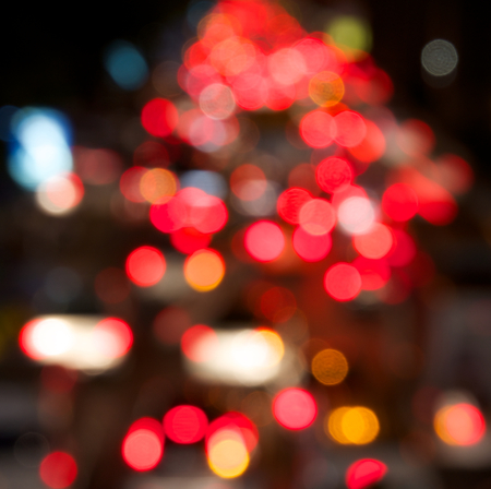 Red, pink bokeh glitter from traffic at the night background.の写真素材