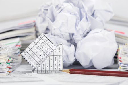 Close up bankruptcy of house with pencil on finance account have blur stack of paper ball between...