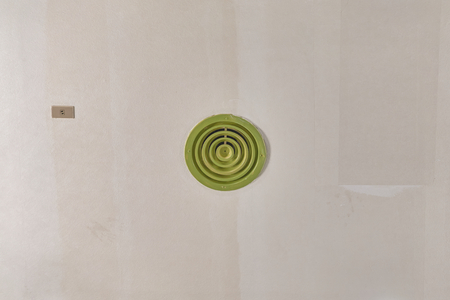 Green round outlet of air condition on ceiling with copy space.の写真素材
