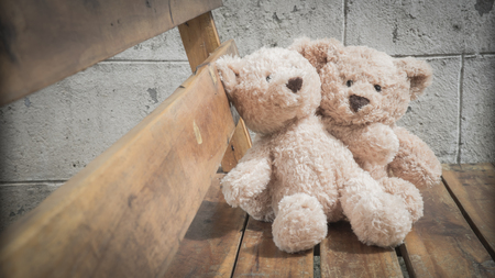 teddybears in the park on a benchの写真素材