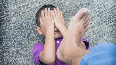Young Asian boy being physically abused by someone older than him