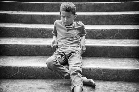 Young Asian homeless child looking scared, alone and in need of helpの写真素材