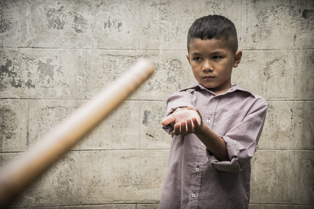 Young Asian boy being physically abused by someone older than himの写真素材