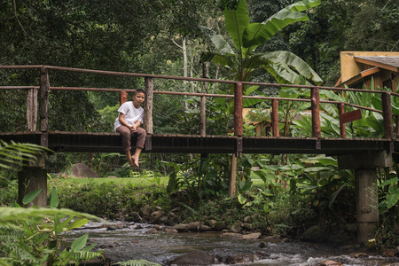 scared and alone, young  Asian child who is at high risk of being bullied, trafficked and abused, selective focusの写真素材