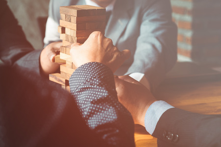 Balancing important issues at the office, concept using wooden stacked blocks