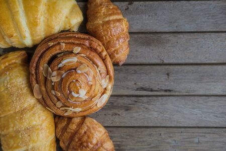 fresh bread and baked goods on wooden chopping board, rustic styleの写真素材