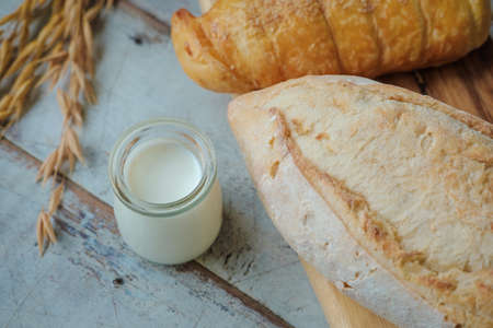 fresh bread and baked goods on wooden chopping board, rustic style