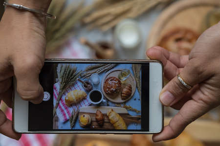 fresh bread and baked goods on wooden chopping board, rustic styleの写真素材