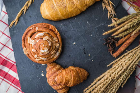 fresh bread and baked goods on wooden chopping board, rustic styleの写真素材