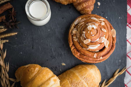 fresh bread and baked goods on wooden chopping board, rustic style