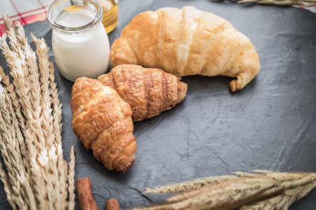 fresh bread and baked goods on wooden chopping board, rustic styleの写真素材