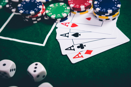 Gambling chips and cards on a green cloth Casino table