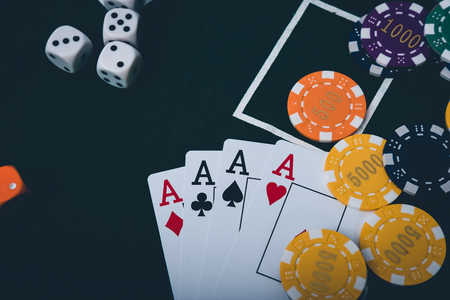 Gambling chips and cards on a green cloth Casino table