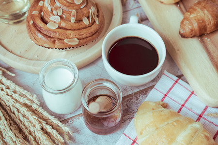 Coffee and fresh breads served for breakfast on wooden trays, a perfect way to start the dayの写真素材
