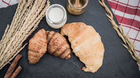 fresh bread and baked goods on wooden chopping board, rustic styleの写真素材