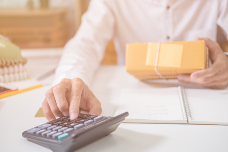 Calculating the cost of postage of a small package, Small business enterprise concerns for online Shoppingの写真素材