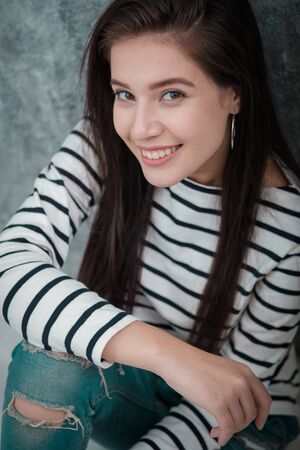 Beautiful young girl smiling, looking happy and carefreeの写真素材