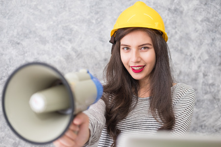 Portrait of a Beautiful young woman holding megaphone.の写真素材