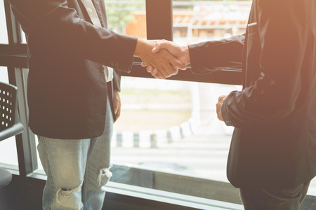 Business men shaking hands, Agree on businessの写真素材