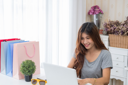 Young beautiful girl working on the laptop at the office aloneの写真素材