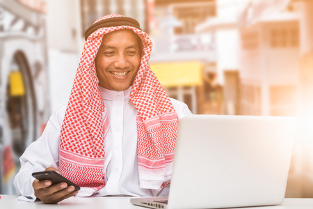 Arab business man sitting at a desk in the officeの写真素材