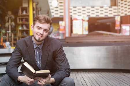 Closeup on a man reading a bible at shopping mall, believe conceptの写真素材