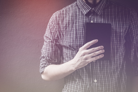 Closeup on a man holding a bible at shopping mall, believe conceptの写真素材