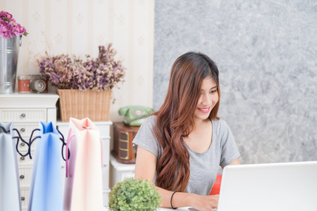 A business woman working on the laptop at home officeの写真素材