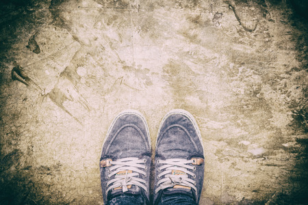 Looking down on feet standing alone, alone concept