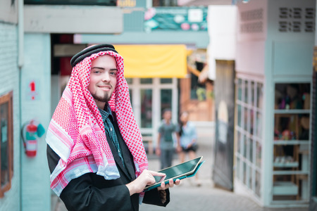 Arab business man standing and working at his market, business conceptの写真素材