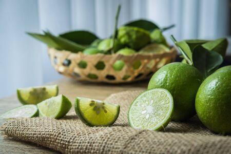Backgrounds. Close up shot of wet limes. Focus on the central part of sliced lime.の写真素材