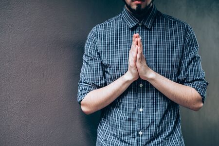Closeup on a young man pray, believe conceptの写真素材