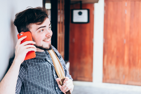 portrait of a happy man use his phone in the marketの写真素材