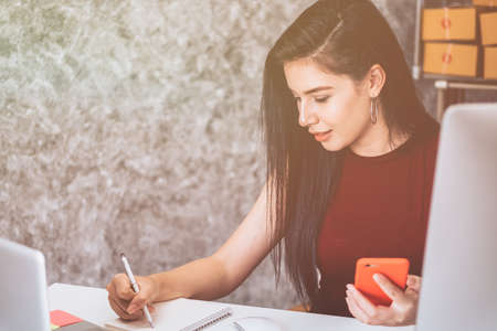 Calculating the cost of postage of a small package, Small business enterprise concerns for online Shoppingの写真素材