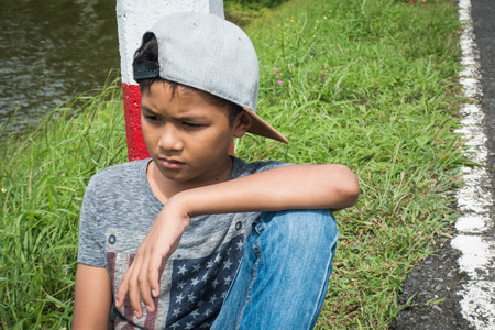 young asian boy feeling Alone and scaredの写真素材