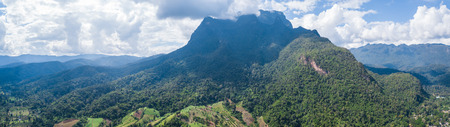 Aerial top view photo from flying drone of the Buddhist temple and fields in  the countryside of Chiang Mai, Northern Thailandの写真素材