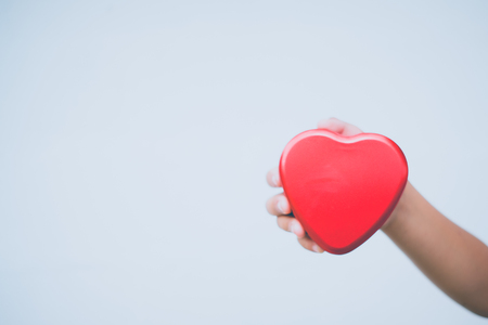 hand holding a red heart, valentine's day love, vintage tone の写真素材