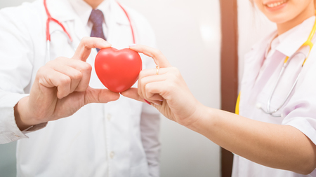 teamwork of doctor hand holding a red heart, blood donate concept の写真素材