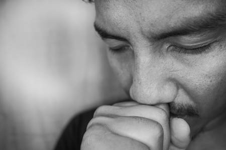 young Asian man are depressed and alone at home, fearの写真素材
