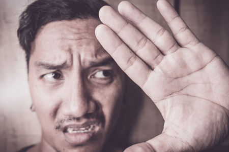 young Asian man are depressed and alone at home, fearの写真素材