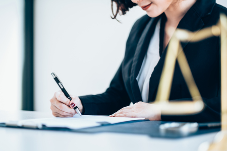A business woman working on the laptop at the office, Looking for direction and inspiration, Office desk table with computer, supplies, Copy space for textの写真素材