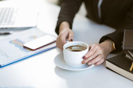 young beautiful asian business woman taking a coffee break  
