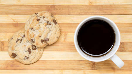 Black coffee and chocolate macadamia cookiesの写真素材