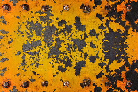 Metal yellow grunge old rusty scratched surface texture with bolt for backgroundの写真素材
