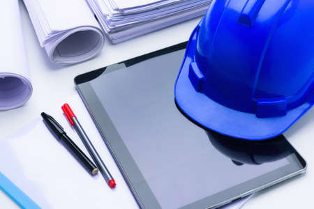 Blue construction helmet notepad, Blue print, pen on table architectural projectの写真素材