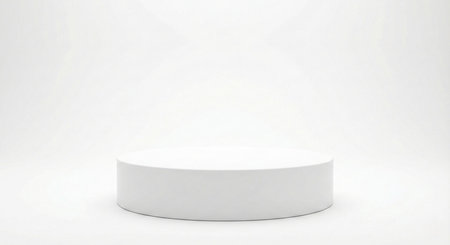 A clean, minimalist white cylindrical podium centered on a seamless white background, ideal for showcasing products with a modern, unobtrusive aesthetic.の素材